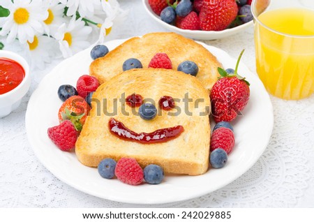Breakfast with a smiling toast, fresh berries, jam and orange juice, a bowl of berries in the background, horizontal