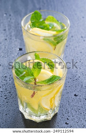 lemonade with mint in glasses on a dark background, vertical, top view