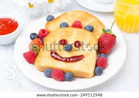 Breakfast with a smiling toast, fresh berries, berry jam and orange juice, horizontal