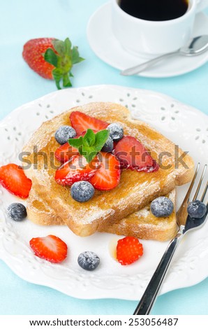 crispy toast with honey, fresh strawberries and blueberries, cup of coffee for breakfast, vertical, closeup