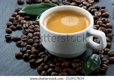 cup of espresso on coffee beans background, selective focus, close-up
