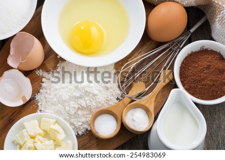 Baking ingredients on a wooden board, top view, close-up