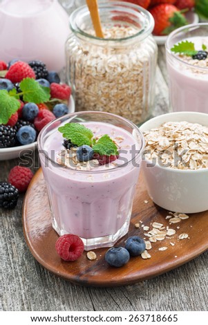 berry smoothie with oatmeal in a glass on table, vertical, top view