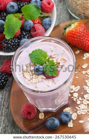 delicious berry smoothies with oatmeal, vertical, top view, close-up