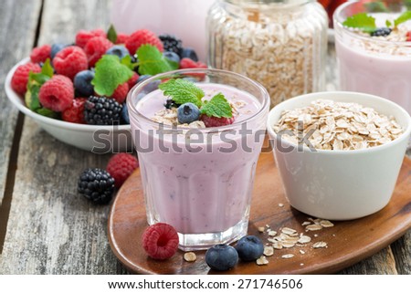 berry smoothie with oatmeal in a glass on wooden table, close-up