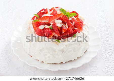 delicious cake with whipped cream and strawberries on a plate, close-up