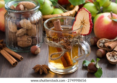 apple cider with spices in glass mug, horizontal, close-up