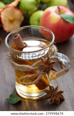 apple cider with spices in a glass cup, selective focus, top view, vertical