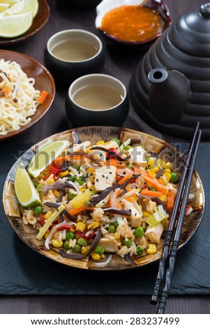 asian lunch - fried rice with tofu and vegetables, vertical, close-up