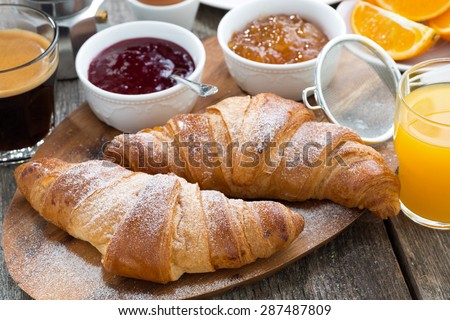 delicious breakfast with fresh croissants on wooden table, close-up, horizontal
