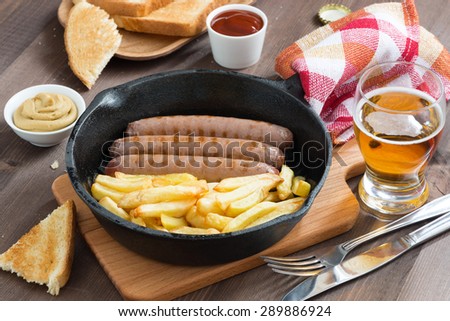 grilled sausages with French fries and toast for lunch, top view, horizontal