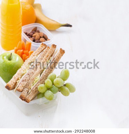 school lunch with sandwich on white wooden table, close-up