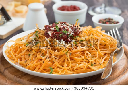 Italian food - pasta with tomato sauce and cheese, close-up, horizontal