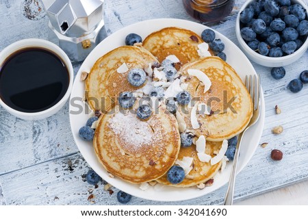 pancakes with fresh blueberries and honey for breakfast, top view, horizontal