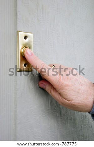 Lady\'s finger pushing a door bell push button