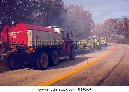fire tenders parked by the highway as their crews fight a blaze in the Ozark Mountains
