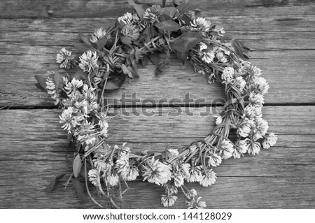 wreath from meadow flowers, a black-and-white photo