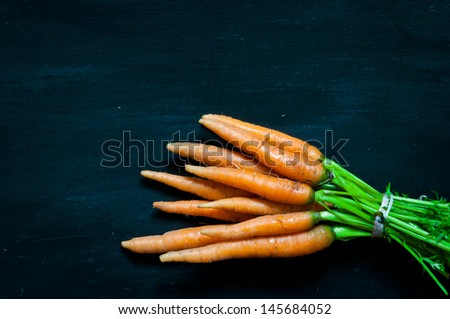 organic carrots on a black background