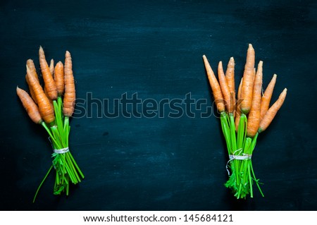 ripe carrots on a black background
