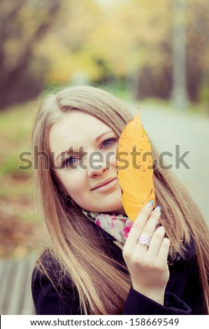 Portrait of the attractive young woman  against the nature of fall