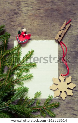 Christmas fir tree with paper and  decoration on a wooden board