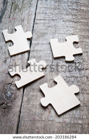 Puzzle on wooden boards team business concept