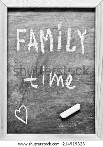 Family time written with Chalk on Blackboard