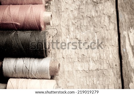 Vintage Background with  bobbins with thread  on the old wooden background