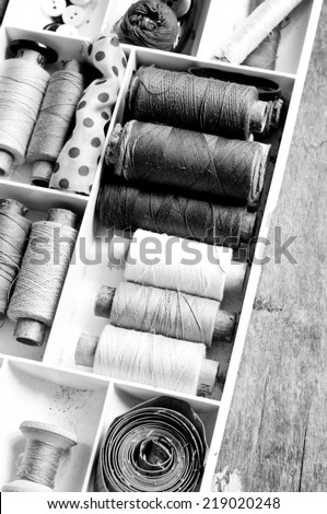 Vintage Background with sewing/Sewing kit.Bobbins with thread and needles