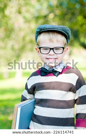 Portrait of a cute smart boy wearing spectacles. Education.  Outdoors.
