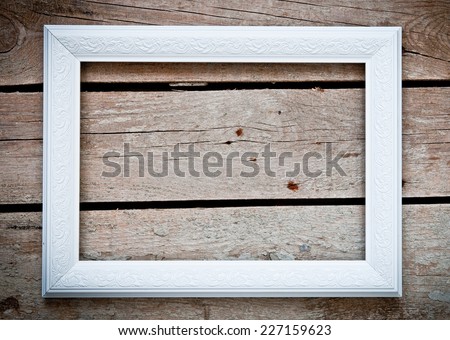 white frame over rustic wooden background