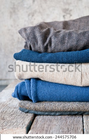 Pile of clothes on a wooden background