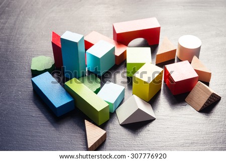 Wooden building blocks on a black