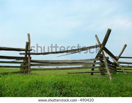 Split rail fence with sky and grass
