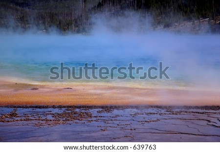 Steam rises off Grand Prismatic Hot Spring - mud flat in foreground