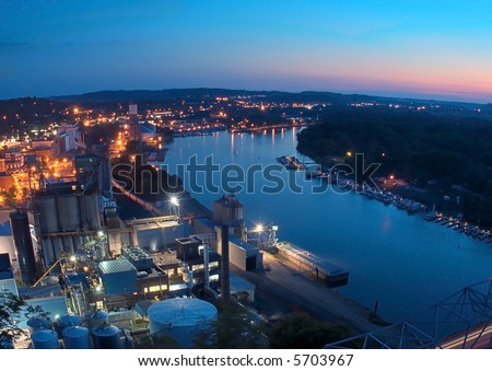 Downtown Red Wing Minnesota with sunset - industrial site and bridge to Wisconsin in foreground