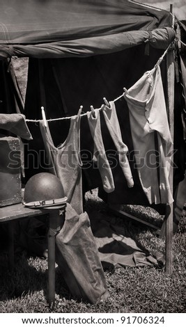 Laundry on the Line - Army tent with line of military issue clothing drying in the sun