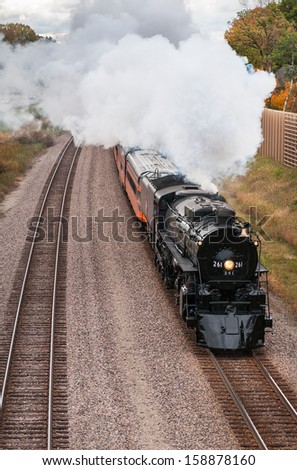 LONG LAKE, MN - OCTOBER 12: Fall colors excursion of the Milwaukee Road #261 Steam Engine from Minneapolis, MN to Willmar, MN. Train steams past railroad siding on October 12, 2013 near Long Lake MN