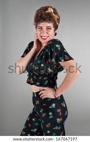 Woman with a Cheeky Grin, wearing a Floral Outfit - on grey background