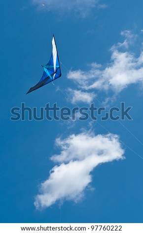 Go Fly a Kite - Blue kite against blue sky and small kite much higher in the sky