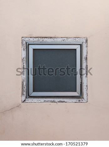square window on beige wall