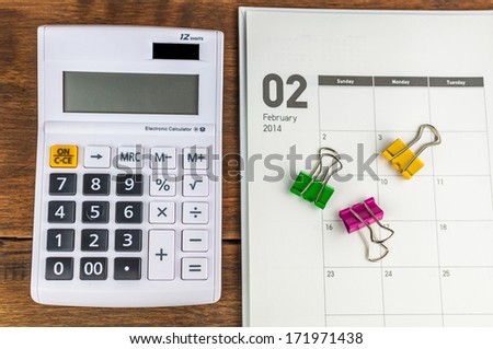 February organizer with calculator & clips: concept for monthly budget.