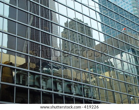 reflection of a street and its buildings in toronto, canada in the mirrored wall of a skyscraper