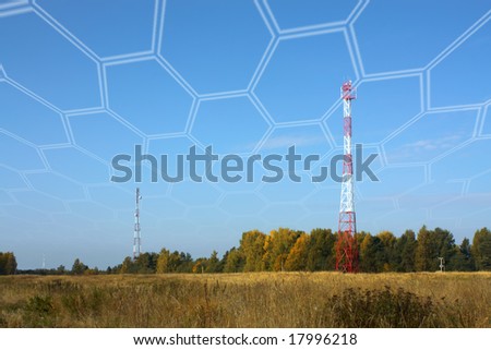 Broadcasting towers of systems of cellular communication on a meadow under the dark blue sky