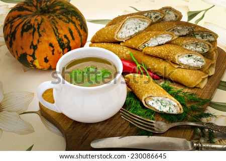 the broth in a ?up and rolls of pancakes with cottage  cheese, herbs and pepper