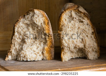 loaf of fresh bread with a crispy crust on a wooden board
