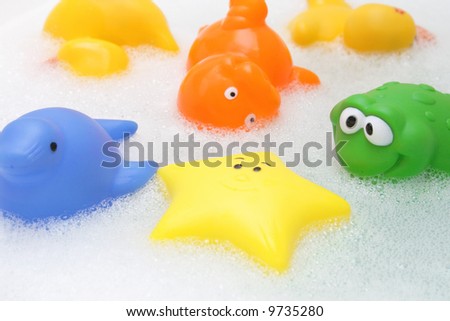 Colorful bath toys in soap water