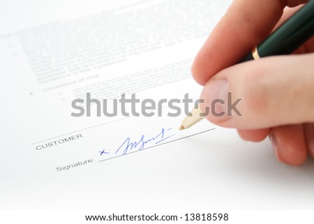 Close-up of pen signing a contract