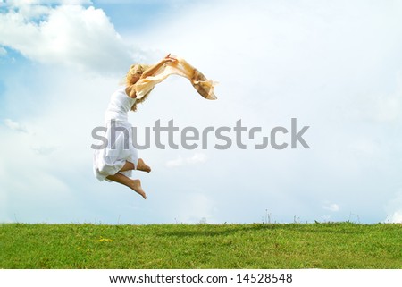 A young lady jumping on the background of the sky