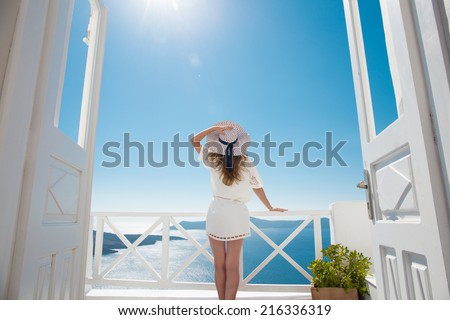 Pretty woman in white dress on Santorini in Creta